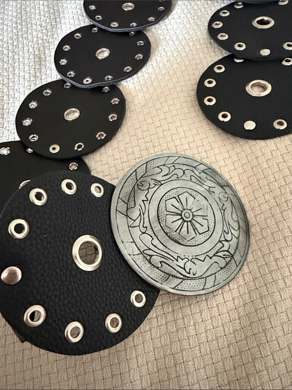 Black Eyelet Disc Stretch Belt with Decorative Silver Medallion